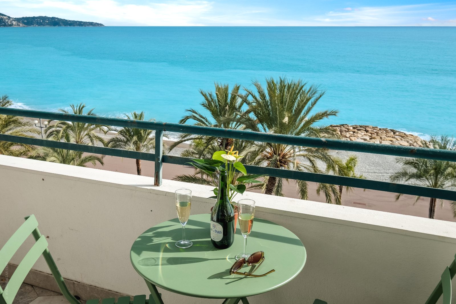 Balcony table set for two above the palms