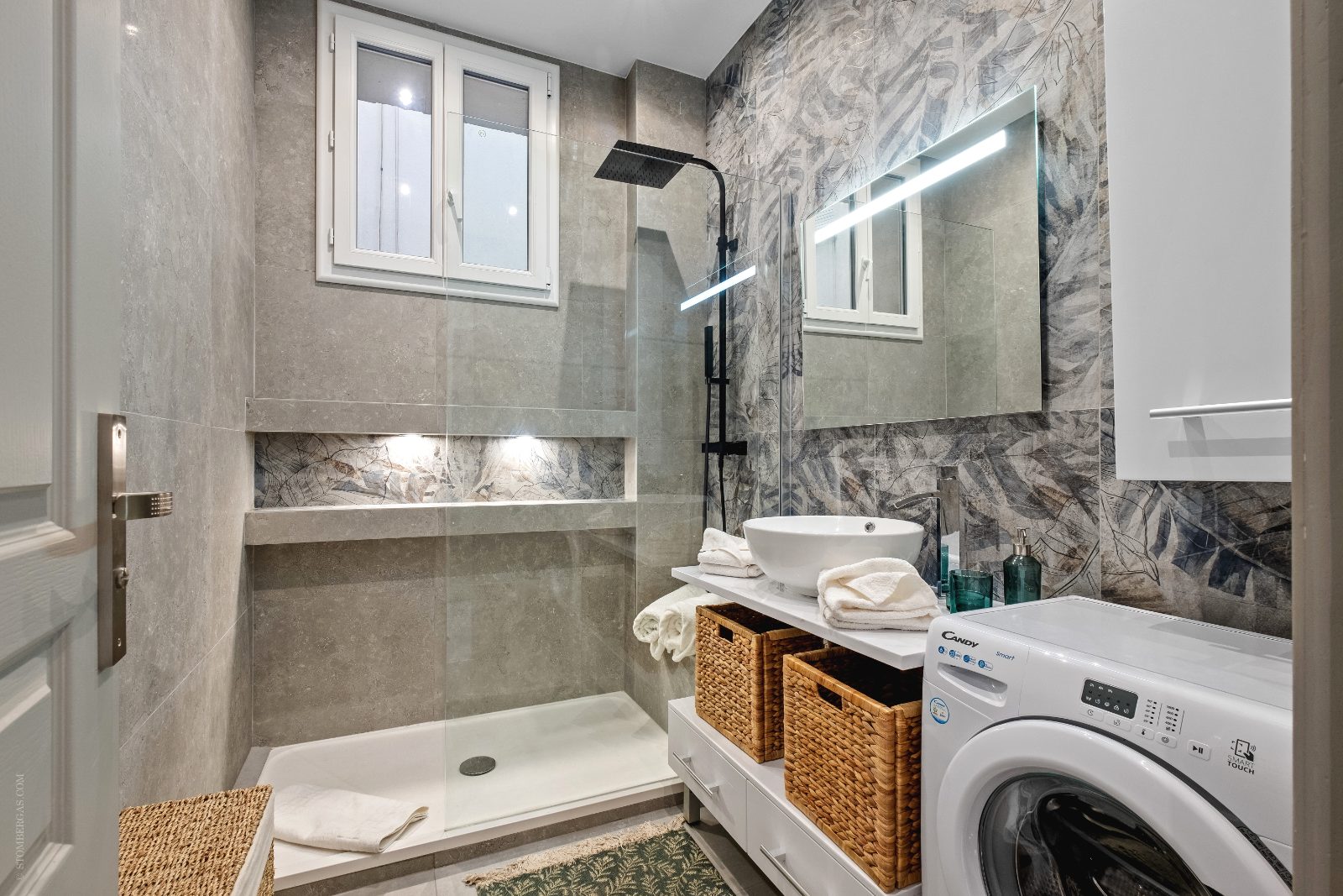 Bathroom with walk-in rain shower, vanity and washer/dryer